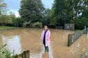 Cllr Jess Bailey in floodwater in Tipton St John.