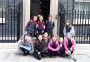 Children from St Mary's Catholic Primary School outside the front door of number 10.