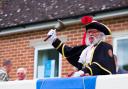 Honiton town crier Dave Retter at the unveiling of the board