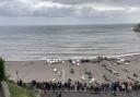 Beer Beach, where people are gathered to get a look at the 'unexploded bomb'.