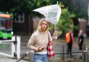 A woman battles with her umbrella as walks in the rain through a wet and windy Winchester in Hampshire. Picture date: Thursday September 5, 2024. PA Photo. See PA story WEATHER Rain. Photo credit should read: Jordan Pettitt/PA Wire