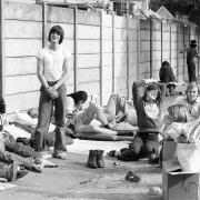 The early morning sun shines down on these tennis fans at Wimbledon. Many fans had camped out all night in the hope of getting tickets for the Men's singles final between Ilie Nastase and Bjorn Born. Date: July 3, 1976.