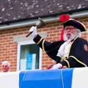 Honiton town crier Dave Retter at the unveiling of the board