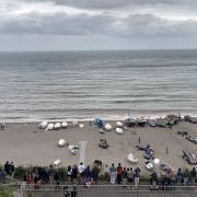 Beer Beach, where people are gathered to get a look at the 'unexploded bomb'.