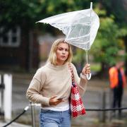 A woman battles with her umbrella as walks in the rain through a wet and windy Winchester in Hampshire. Picture date: Thursday September 5, 2024. PA Photo. See PA story WEATHER Rain. Photo credit should read: Jordan Pettitt/PA Wire