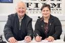 Songwriter Marty Davies and film producer Monika Gergelova exchange contracts