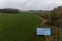 A sign in a field by the M40 near Warwick.