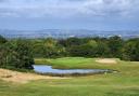 Pictured: One of Woodbury's greens by the pond