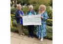 Yvonne Addington hands over to Carol Rowe, secretary for the league, and Mary Bowles, the new facilitator of the monthly memory café meetings