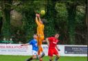 Honiton, in red, mount an attack on the Newton Abbot goal