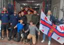 Liberty Trail walkers greeted at Lyme Regis lifeboat station by volunteer crew members Gareth Roscoe and Petrina Muscroft.