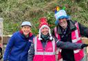 Marilyn Hughes (centre) receives a prize from Event Directors, Carol Austin and Tony Smith for volunteering the most times over the eight years of Seaton parkrun