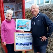 Liz from Coffee and Tots and Simon Wellington with one of his paintings.