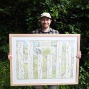 Alex Boon holding one of his maps