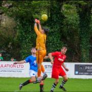 Honiton, in red, mount an attack on the Newton Abbot goal