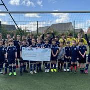 Cranbrook United FC with their cheque