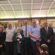 Joshua Denning, fifth from right, is congratulated by members of Lyme Regis Town Council on being awarded the Honorary Freedom of the Town of Lyme Regis.