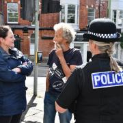 The commissioner speaks to a resident about their concerns