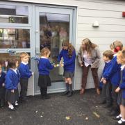 Staff and children officially open the new classroom