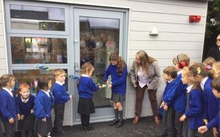 Staff and children officially open the new classroom